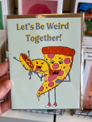 Card with Pizza Taco hot dog design and the text 'Let's Be Weird Together!' held in hand.